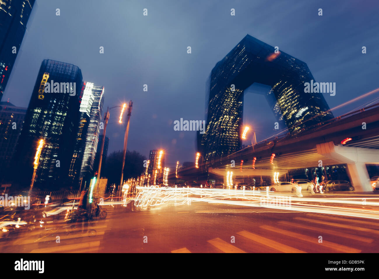 Stock Photo - Beijing, China - October 25, 2015: Abstract blurry image of a night view of CCTV Headquarters Beijing China at the Stock Photo