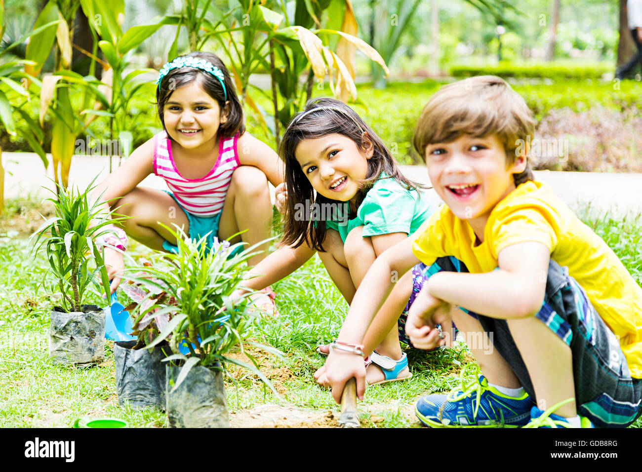 3 indians Kids Friends park Plant Planting Stock Photo