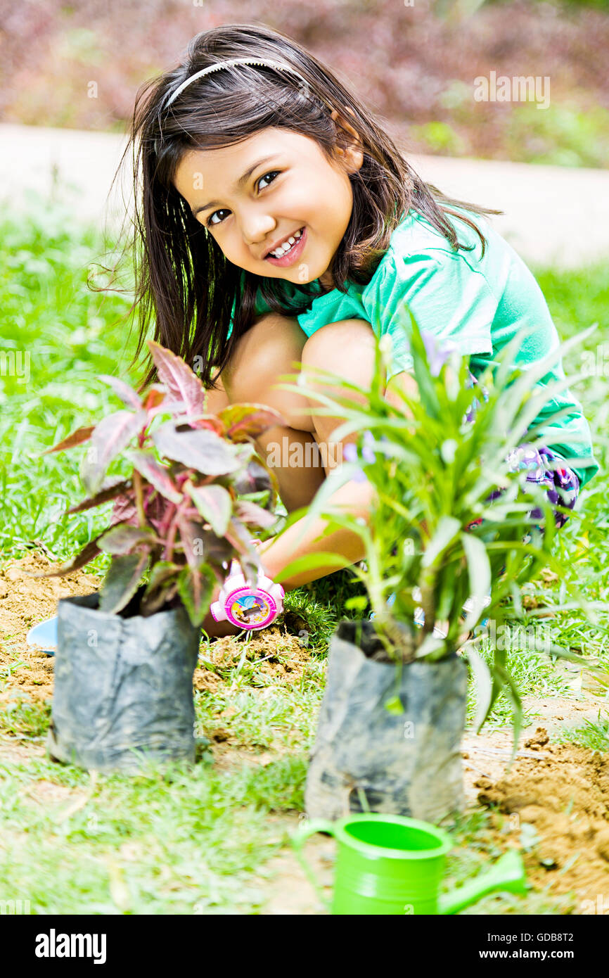 1 indian Kid girl park Plant Planting Stock Photo