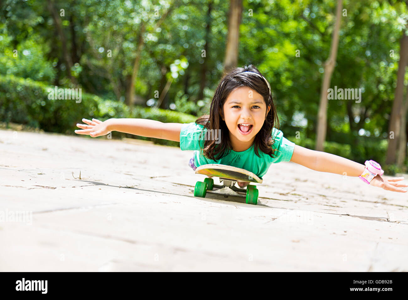 Indian kid girl park skateboard skating hires stock photography and