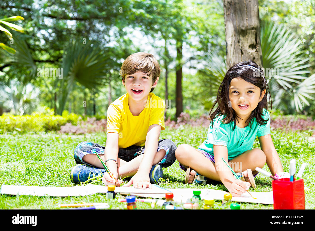 2 indian Kids girl and boy friends Students park Drawing Painting Stock Photo