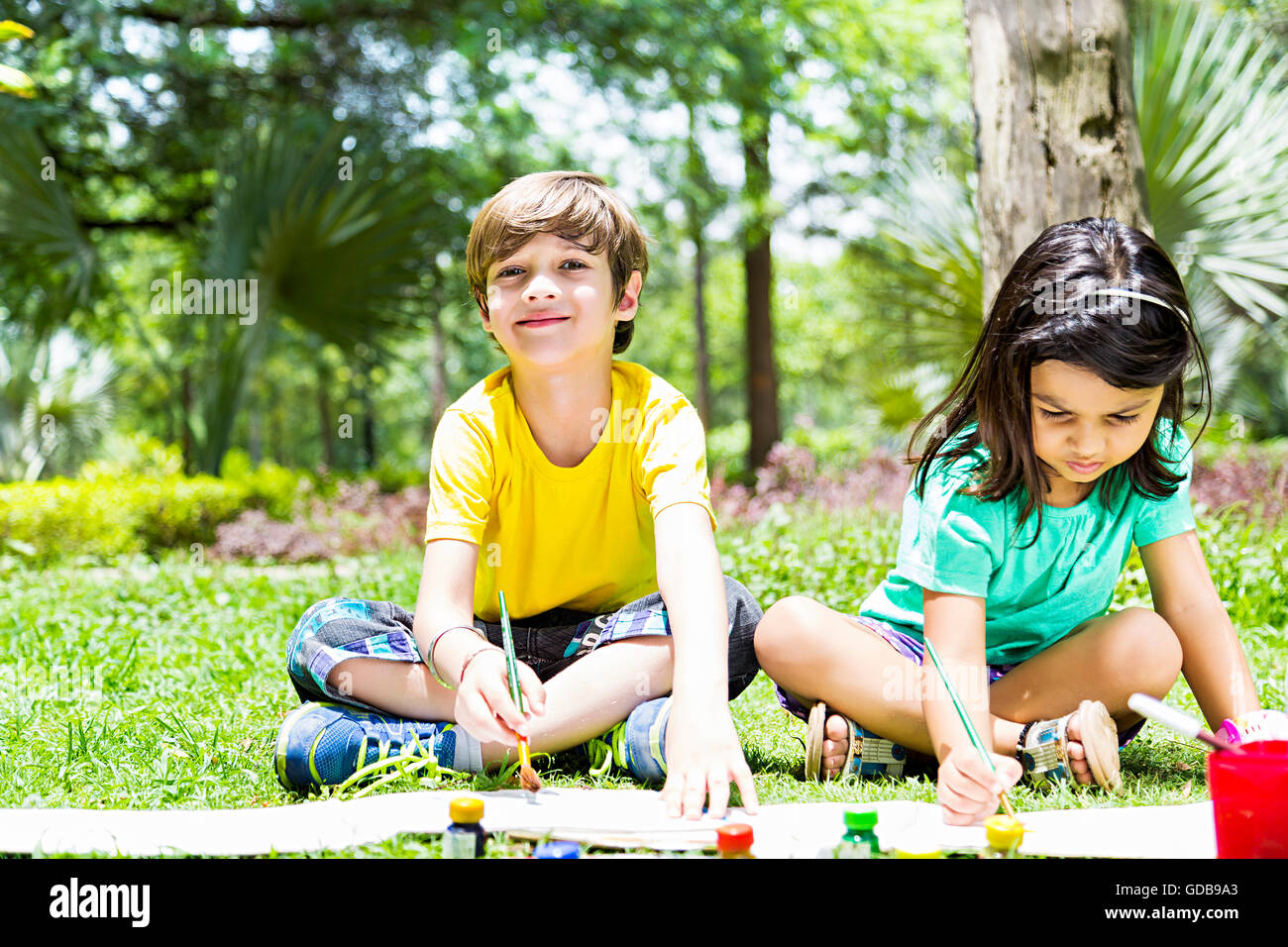 2 indian Kids girl and boy friends Students park Drawing Painting Stock Photo