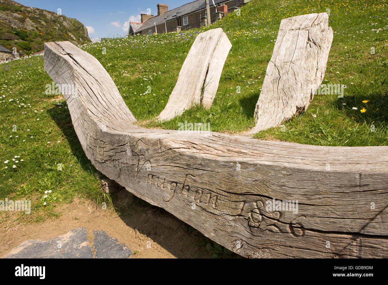 UK, Wales, Gwynedd, Barmouth, wooden seat in shape of boat ribs, carved Lady Vaughan 1826 Stock Photo