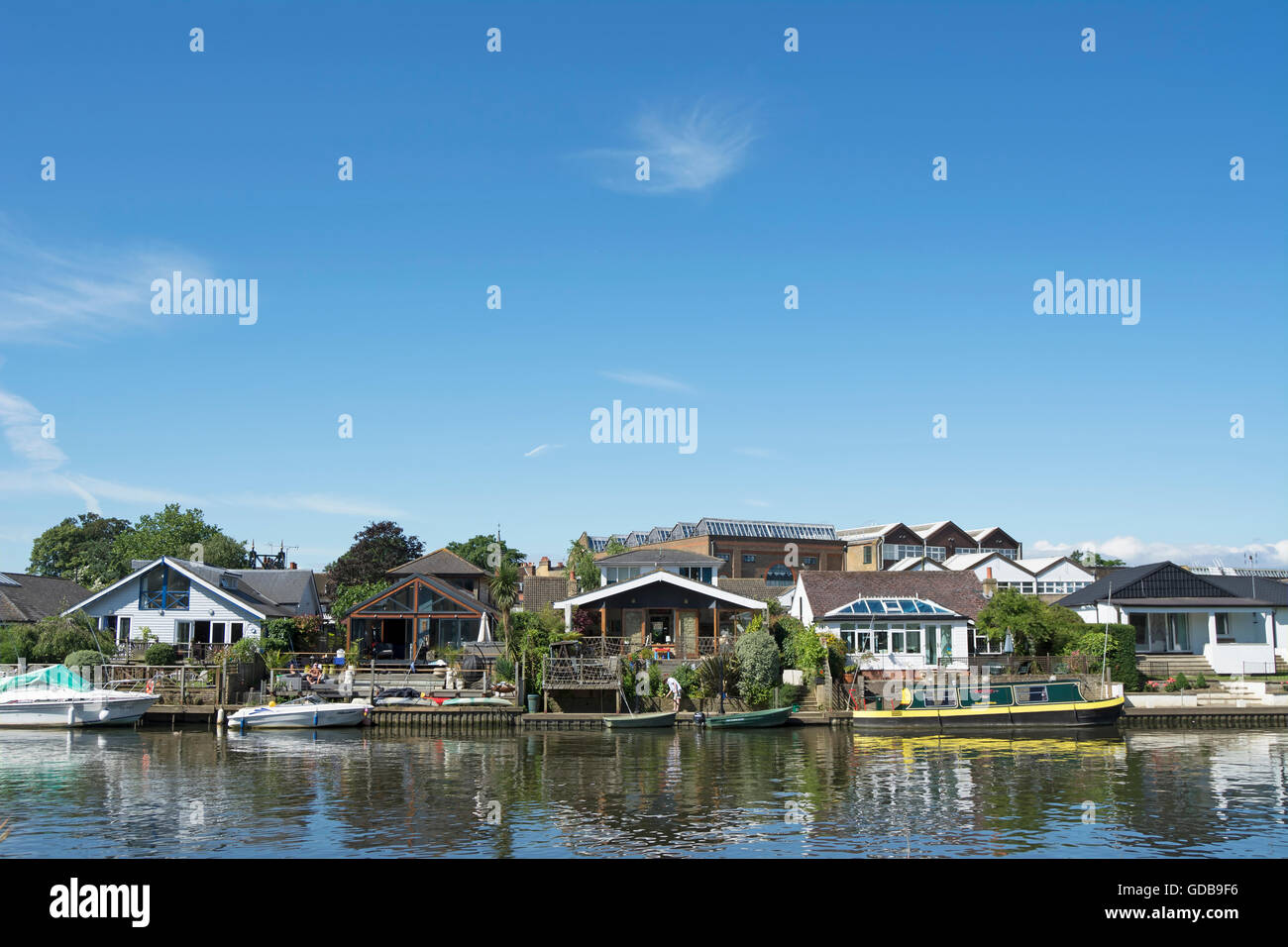 homes lining the river thames in thames ditton, surrey, england, seen from the opposite bank Stock Photo