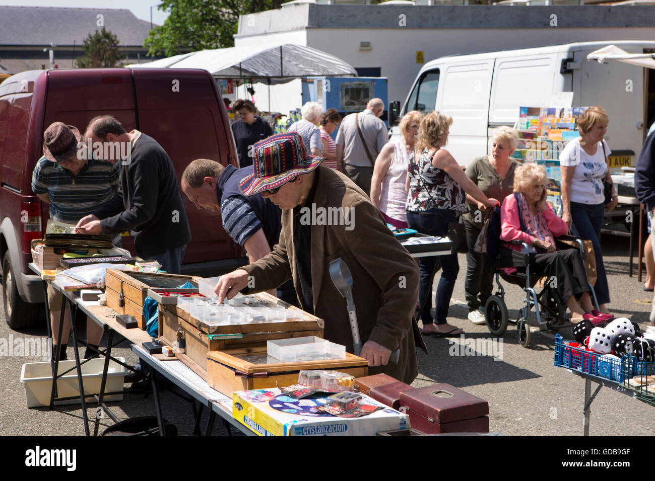 UK, Wales, Gwynedd, Barmouth, weekly market shoppers hunting for bargains on outside stall Stock Photo