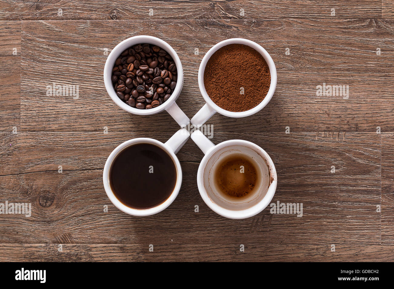 Four cups of coffee, drink phases bean, ground and empty cup Stock Photo Alamy