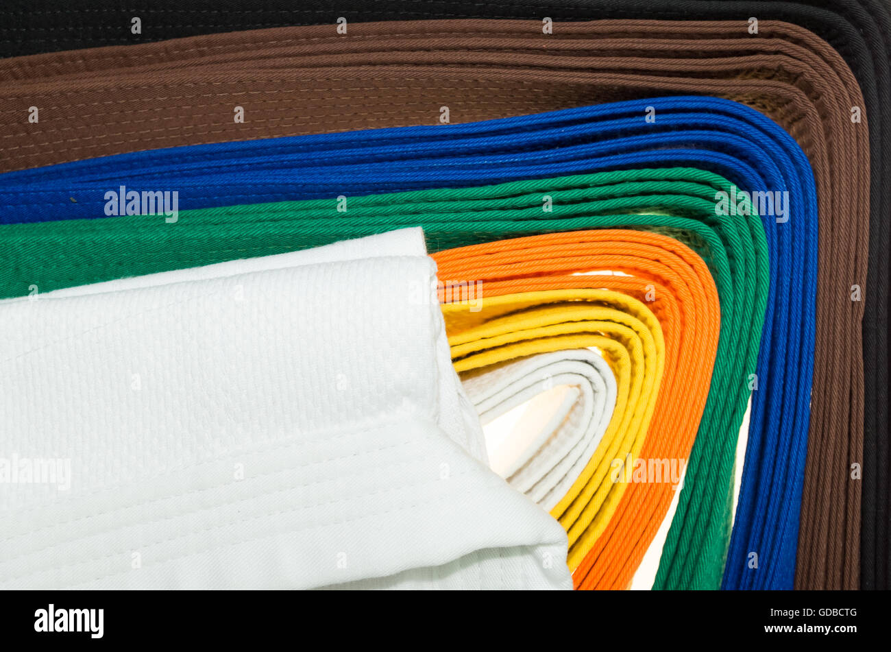 colored belts in martial arts, and a part of judo uniform, for an almost abstract background Stock Photo