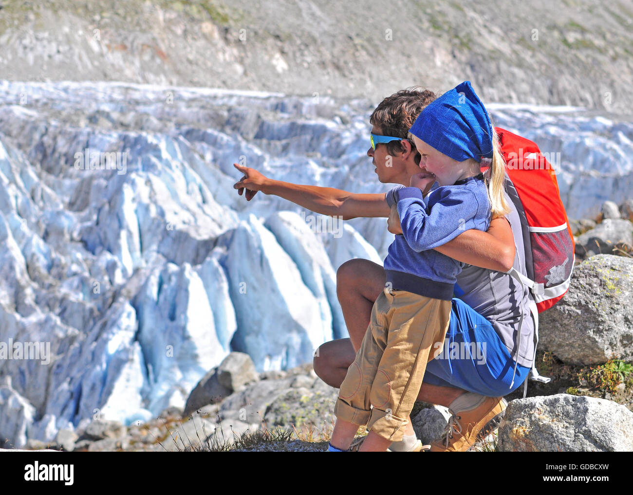 Man with a son at glacier Stock Photo