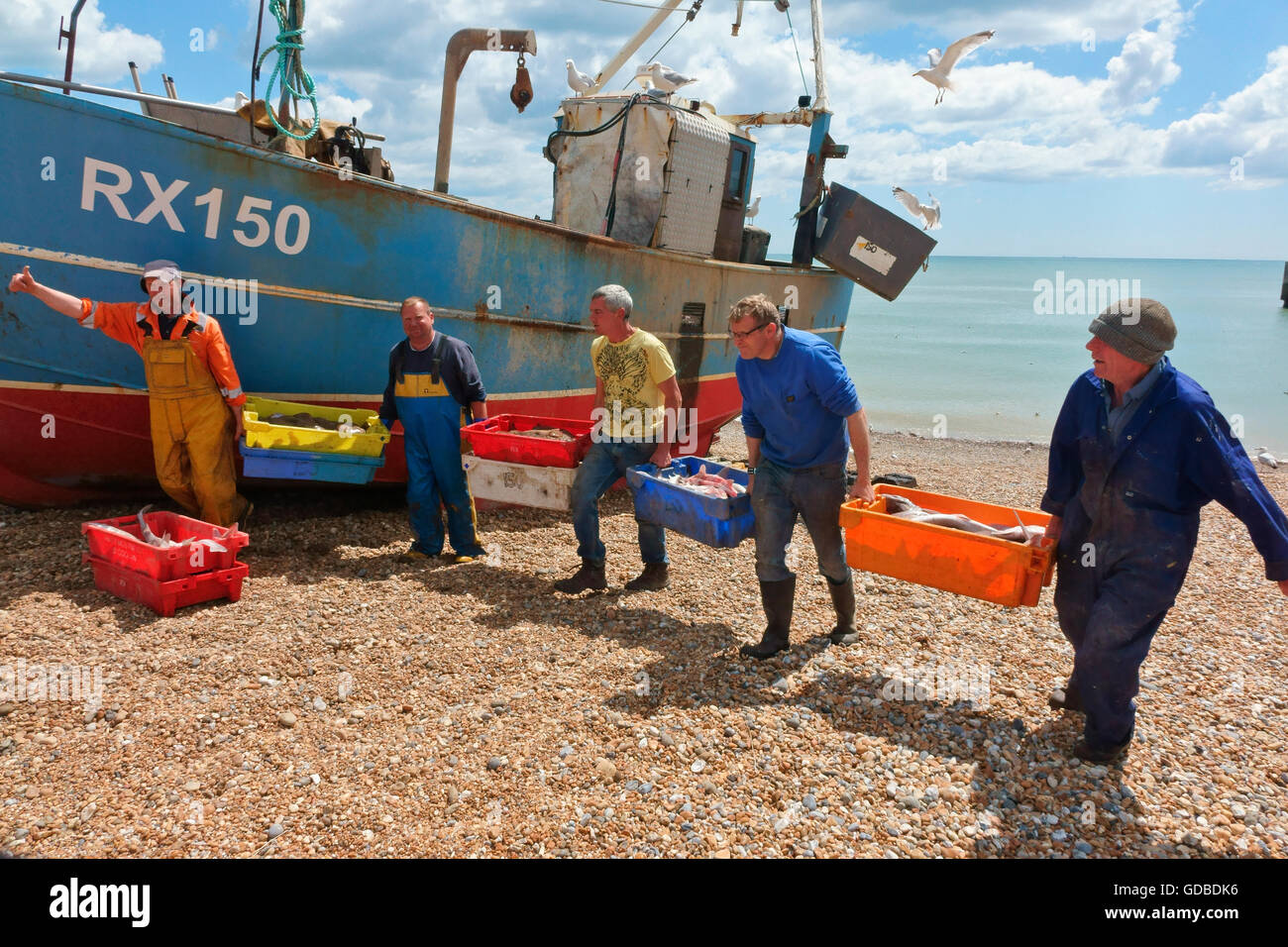 Hastings fishermen unloading catch of fish on the Stade fishermen's beach, East Sussex England Britain UK Stock Photo
