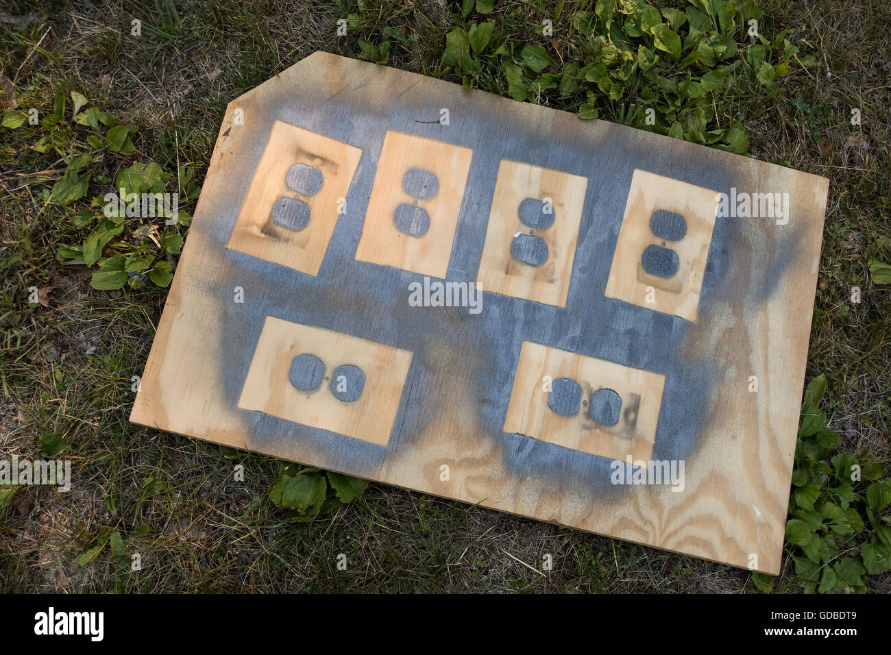 spray painting electrical outlet covers Stock Photo