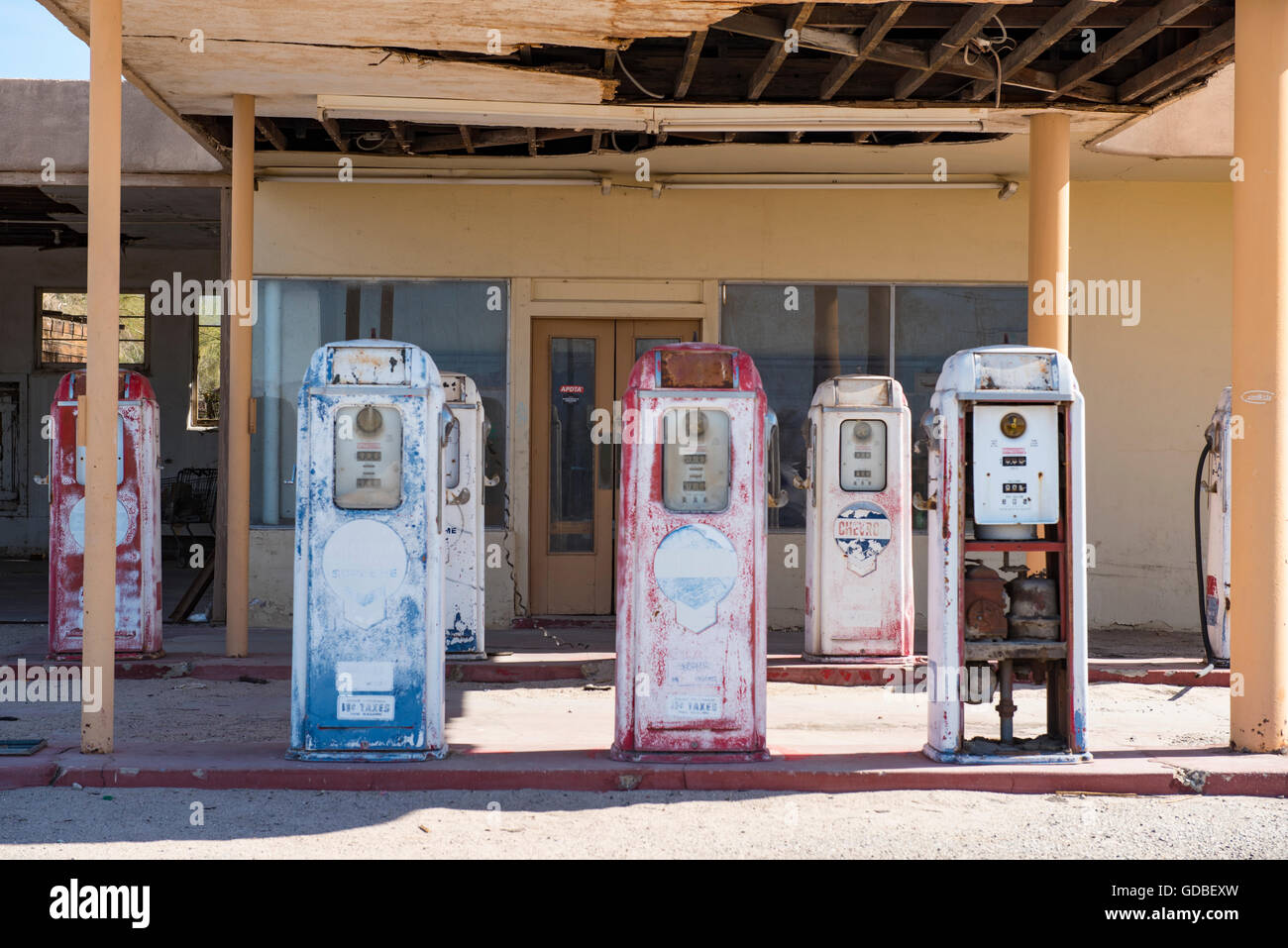 antique, disused gas pumps at ruins of gas station Stock Photo