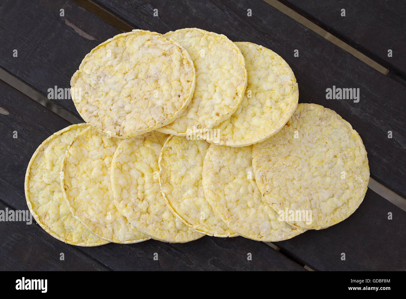 Crunchy round puffed corn cakes snacks on rustic background Stock Photo