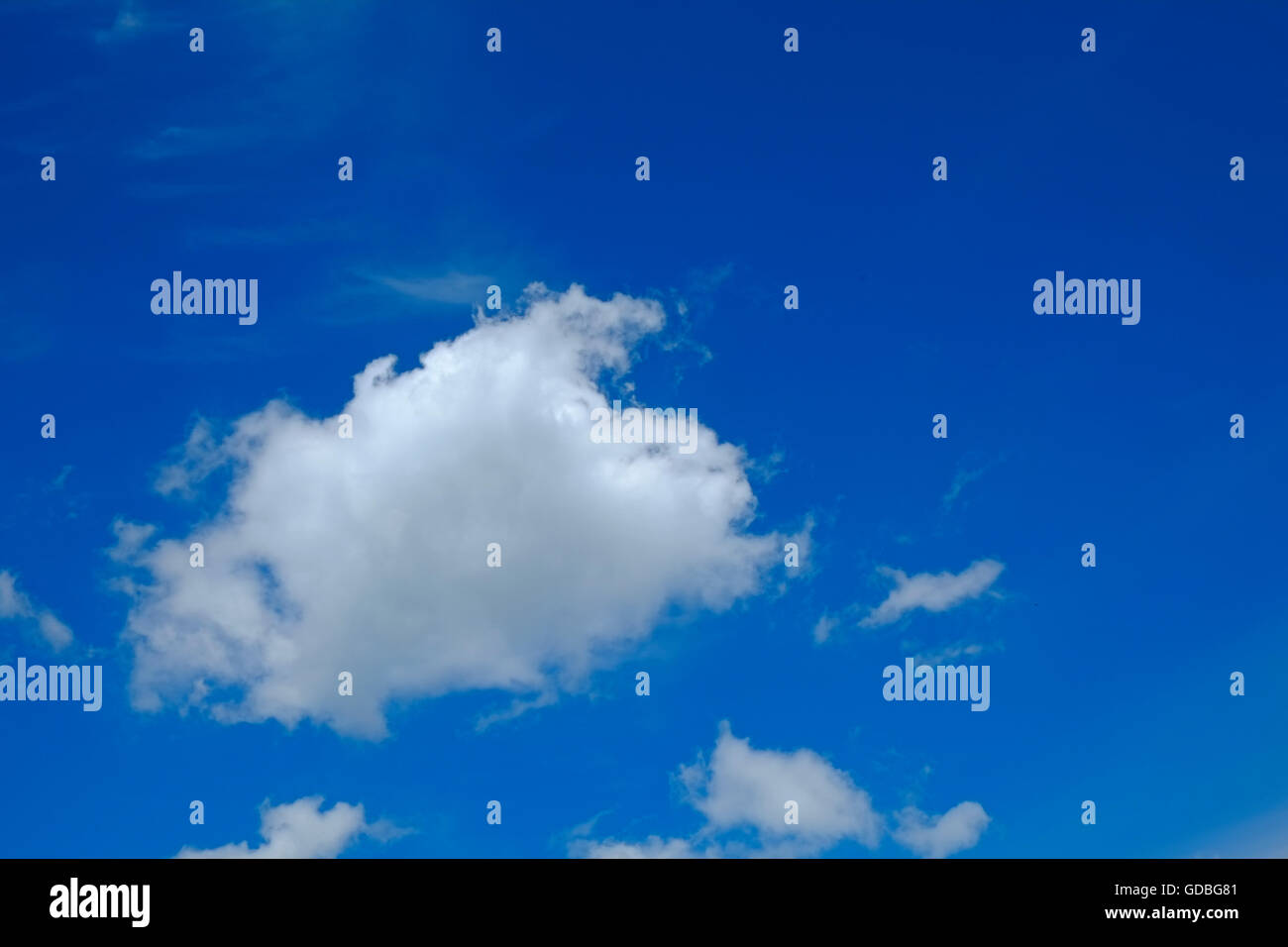 Fluffy clouds in a blue sky Stock Photo - Alamy