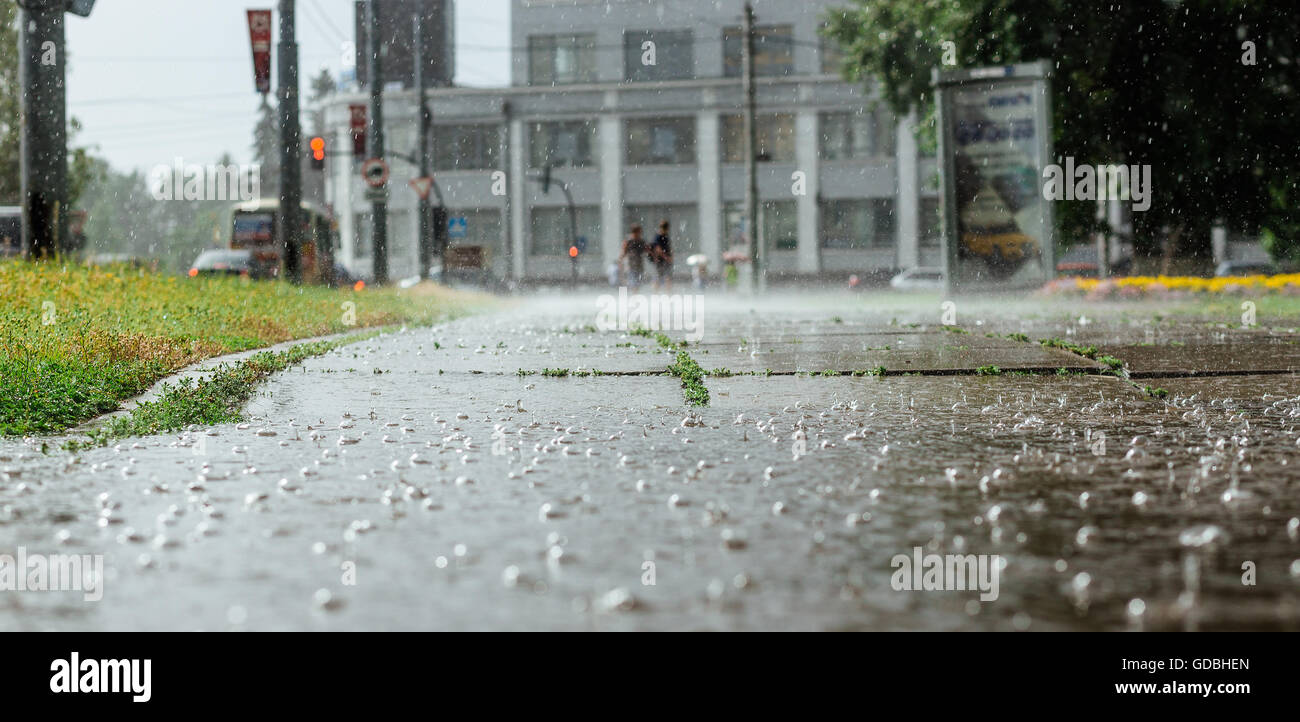 wide picture of bubbles in a puddle rain during heavy stock photo