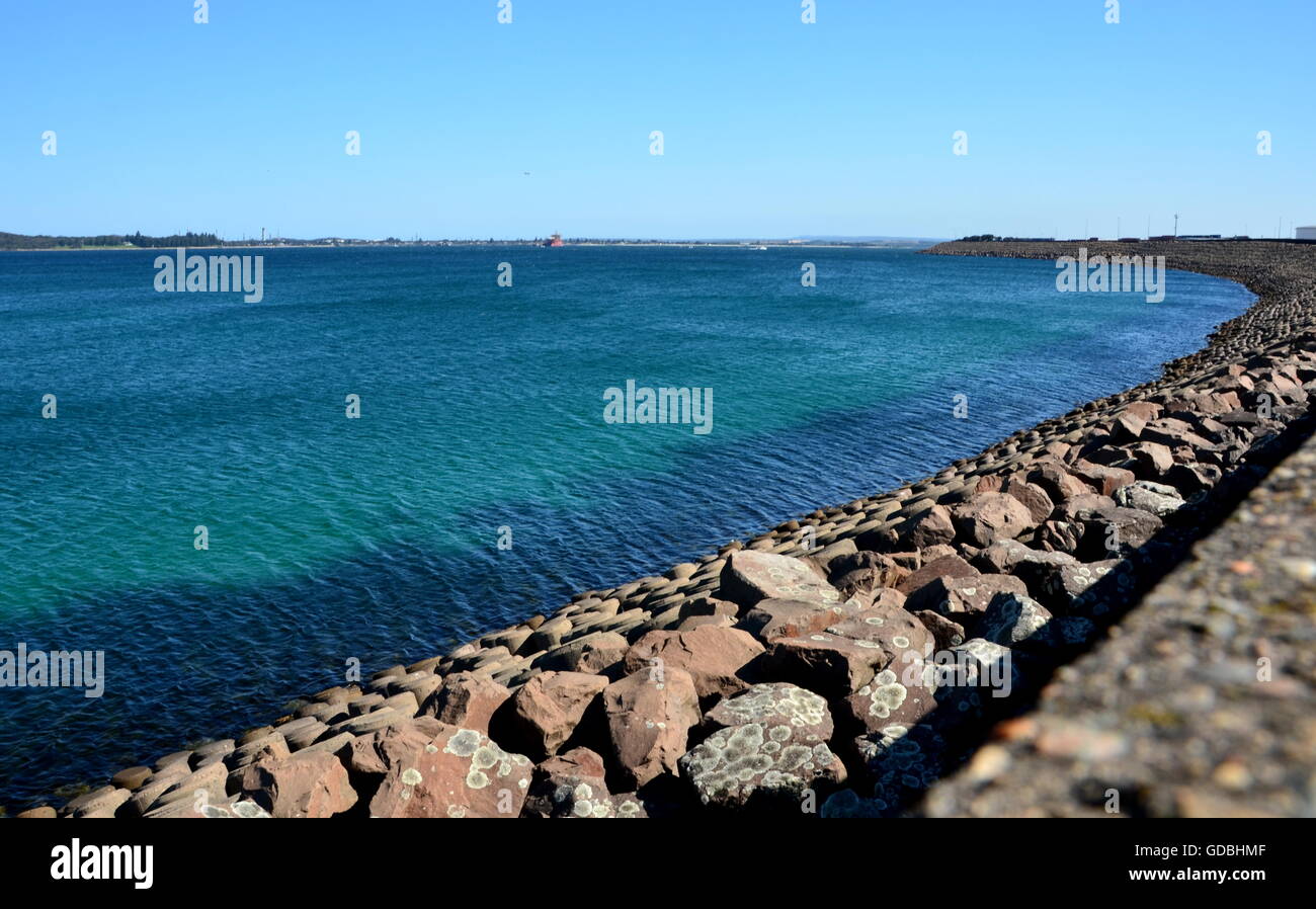 Long rampart separates the industrial area from the sea in Yarra Bay. Stock Photo