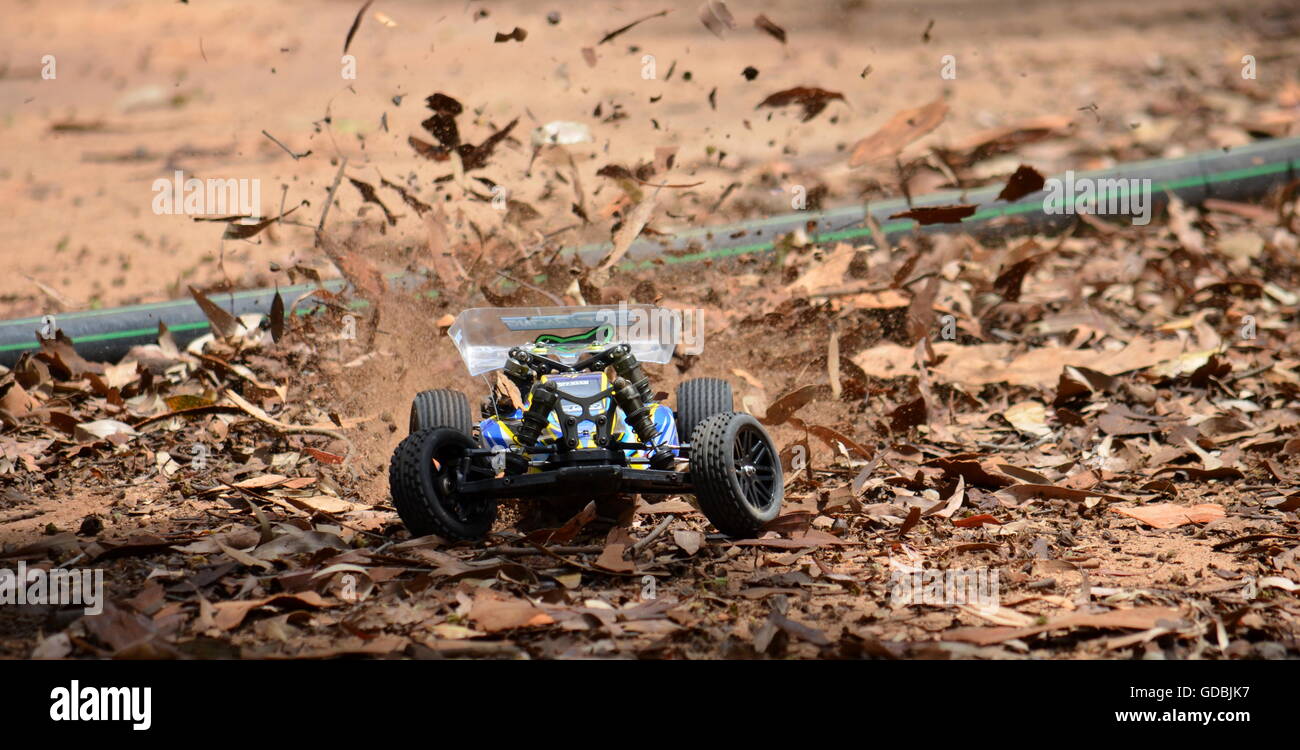 Sydney, Australia - November 30, 2014. Radio controlled buggy car model in race, internal combustion engine on a bumpy red clay  Stock Photo