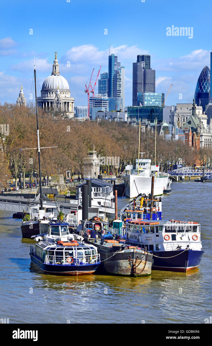 London, England, UK. Boats moored on the River Thames with the City and St Paul's Cathedral in the background Stock Photo