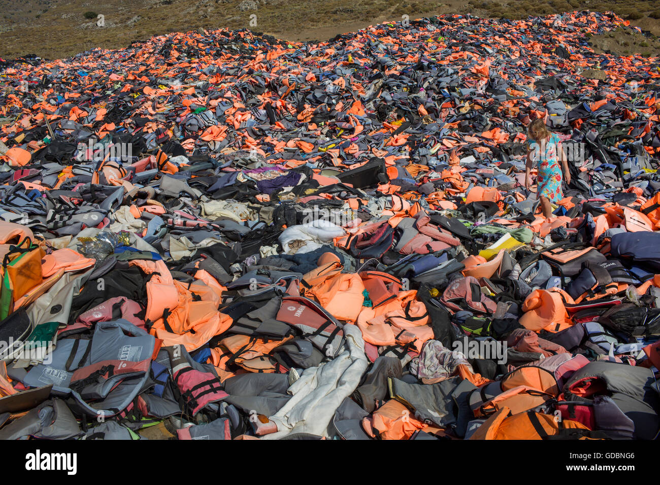 life jackets used by refugees to cross from Turkey to Greece. They are collected and dumped at the waste pit at Lesbos Stock Photo