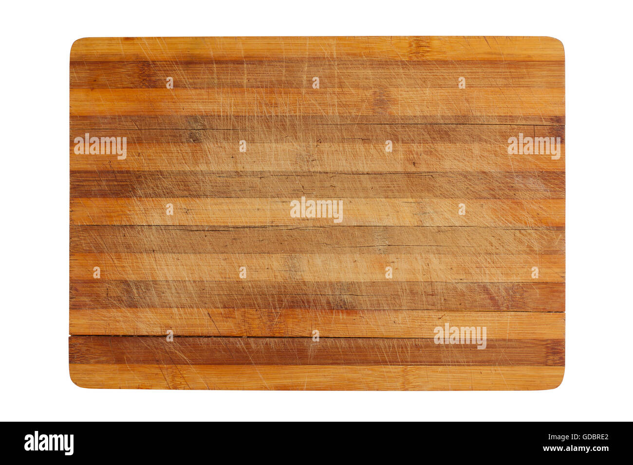 top view of a heavily used wood kitchen cutting board isolated on white
