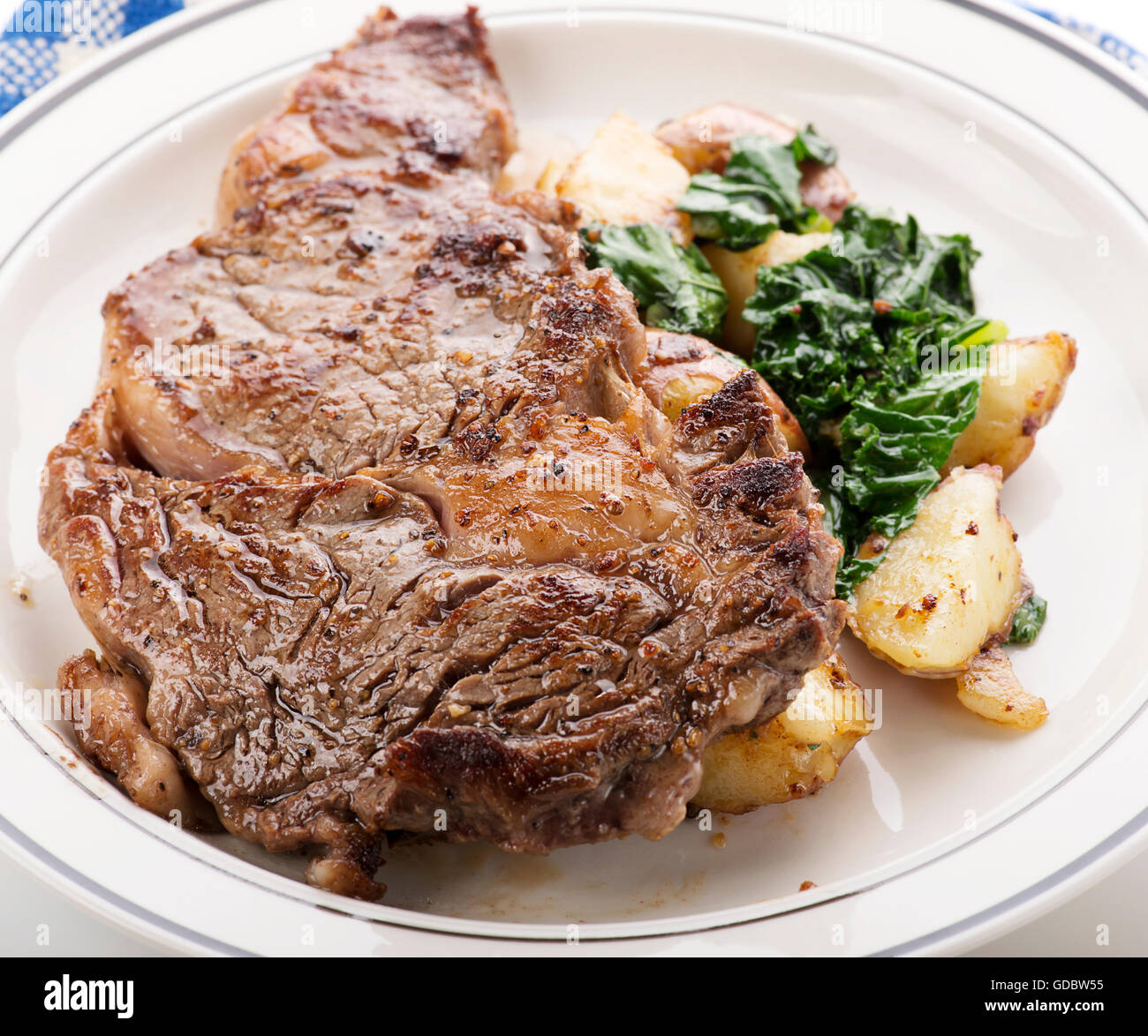 Rib Eye steak with potatoes and spinach Stock Photo Alamy