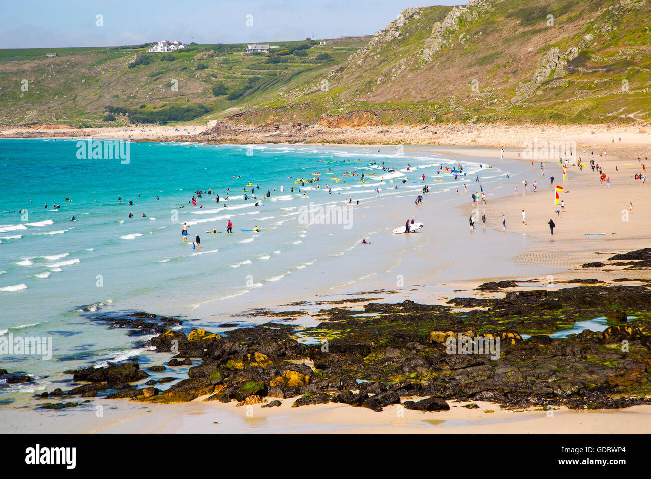 Coastal scenery with busy crowded sandy beach, Sennan Cove, Land's End,  Cornwall, England, UK Stock Photo