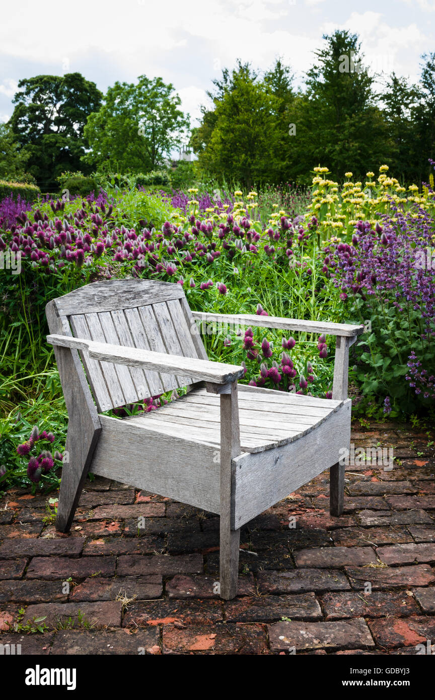 Wooden seat set in English formal garden Stock Photo Alamy