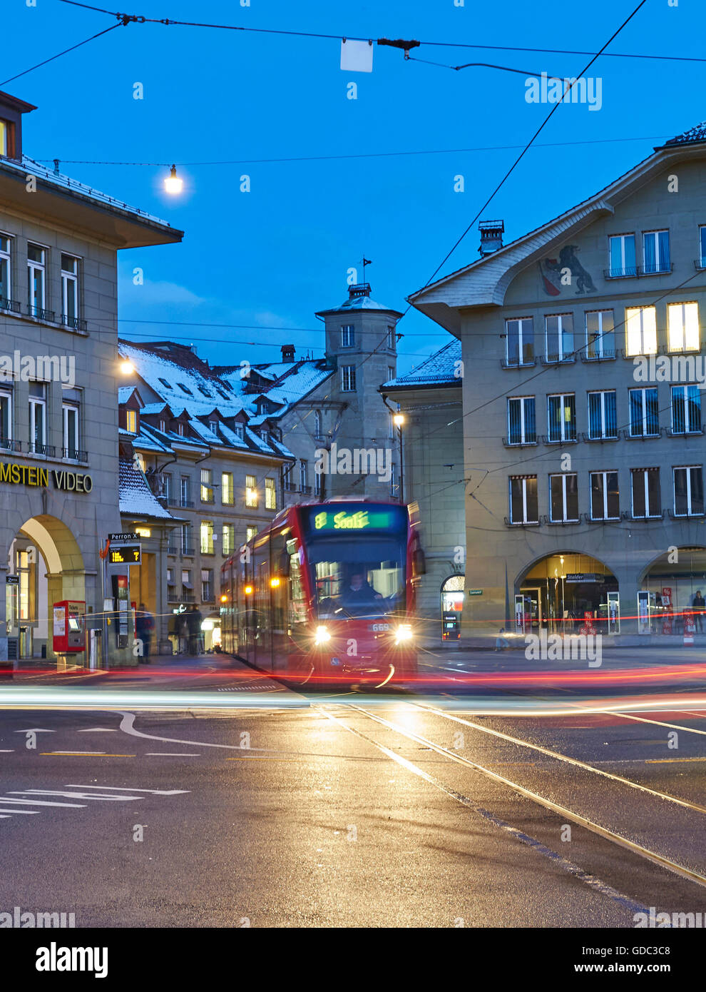 Bern,town,city,Switzerland,Europe,lights,traffic,dusk,twilight,blue hour,cars,automobiles,tram,streetcar,real esta Stock Photo