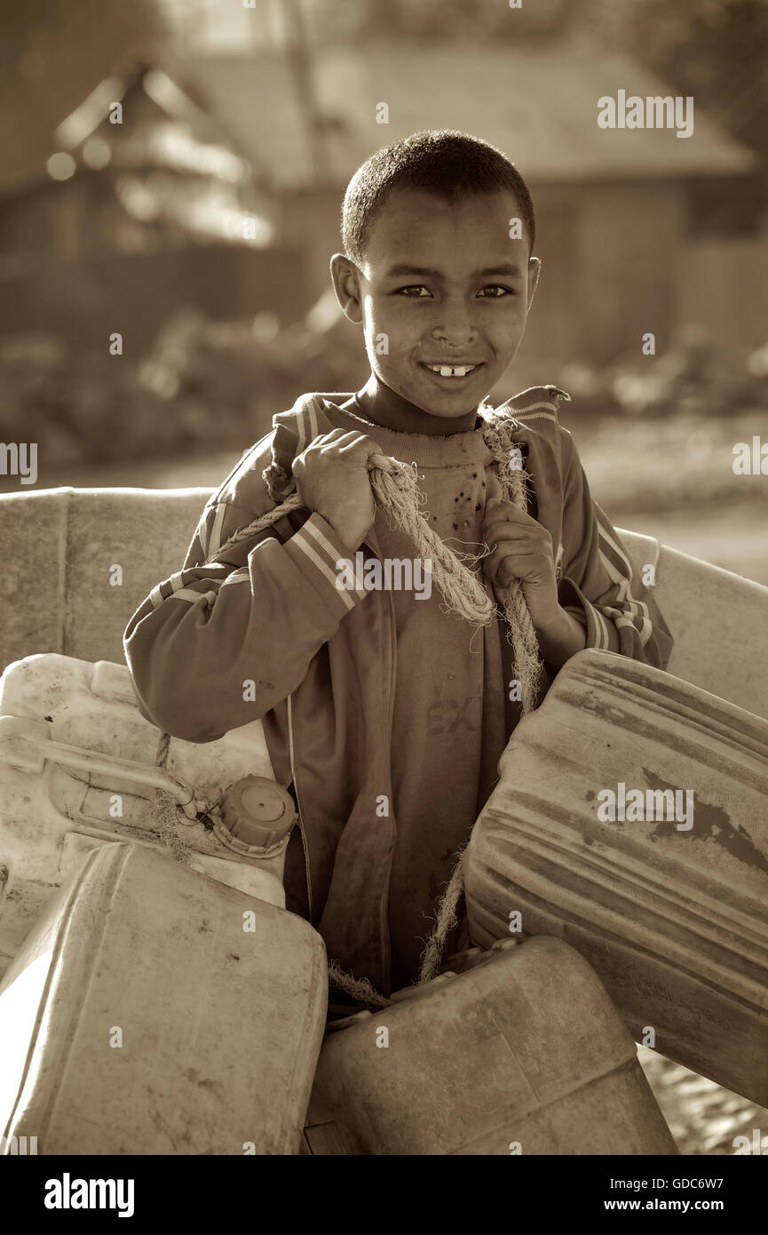 Ethiopian boy collecting containers for money. Child labour, Ethiopia. Stock Photo