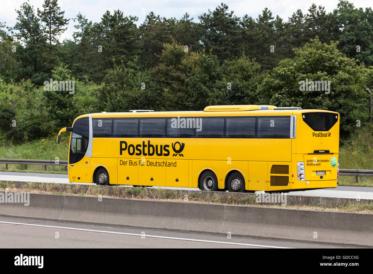 Yellow Postbus on the highway Stock Photo