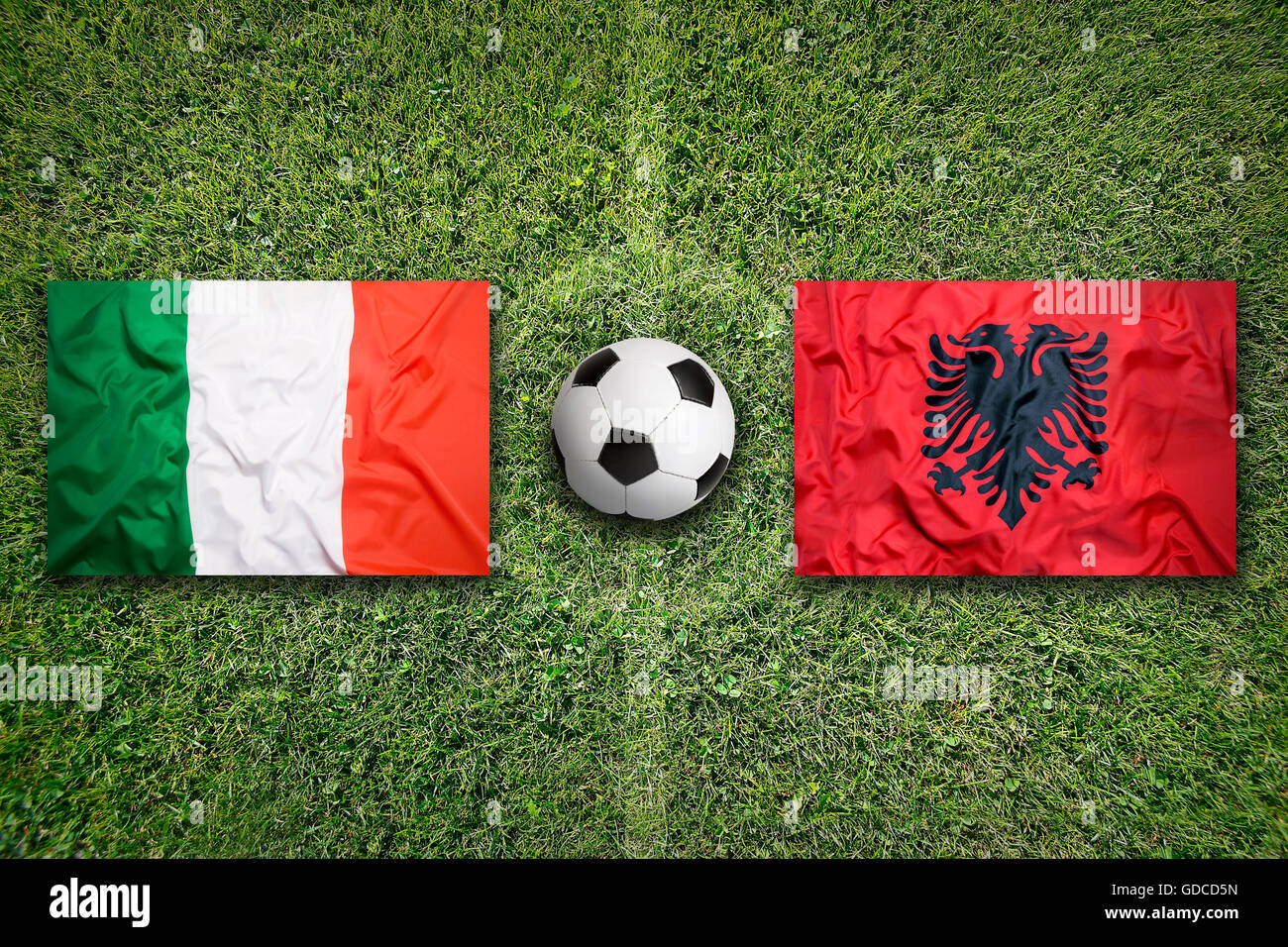 Italy vs. Albania flags on green soccer field Stock Photo - Alamy