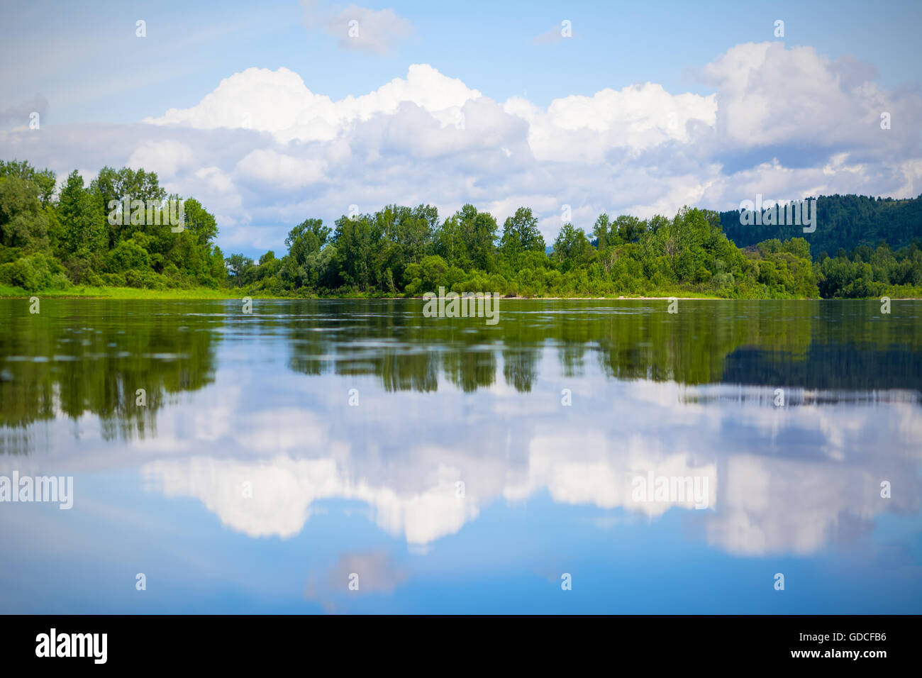 Beautiful landscape with blue sky and white clouds reflected in the ...