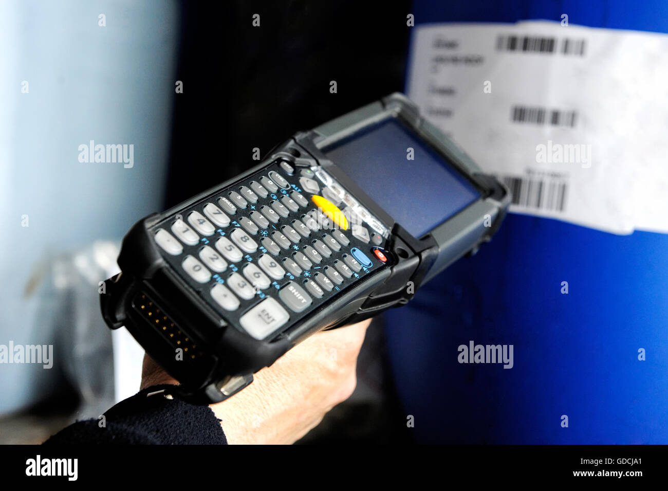 Hand of a person using a bar scanner to read information on a retail product while checking price or inventory in a shop Stock Photo