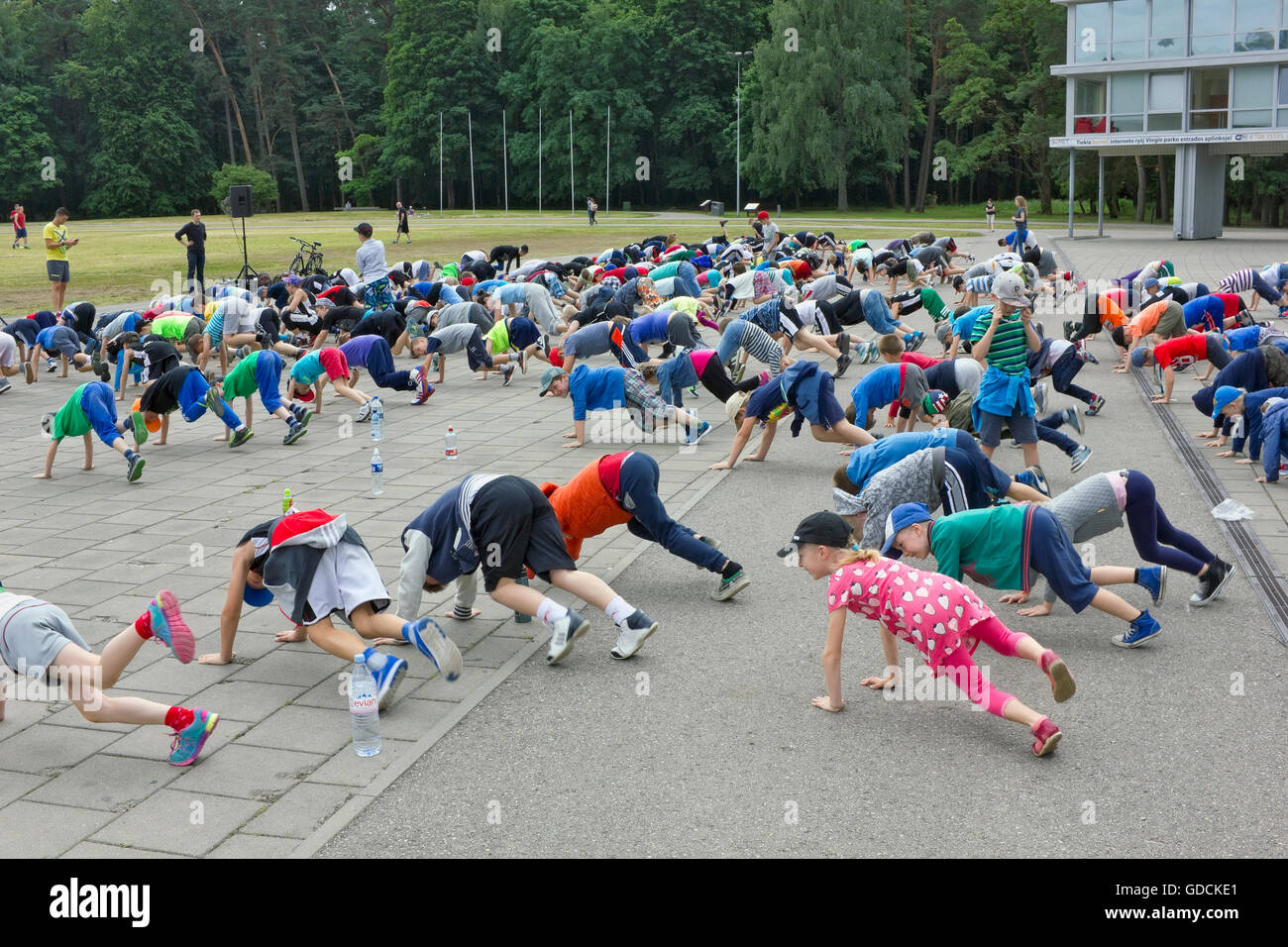 VILNIUS, LITHUANIA - JUNE 17, 2016: Morning sport training of young children -  athletes in the central city park Vingis. Action Stock Photo