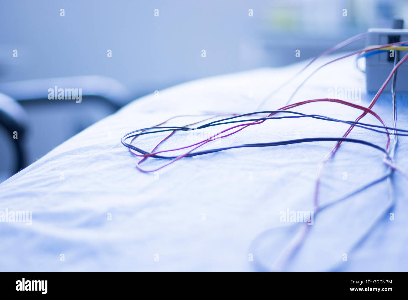 Dry needling electroacupunture cables connecting machine to needles used by acupunturist on