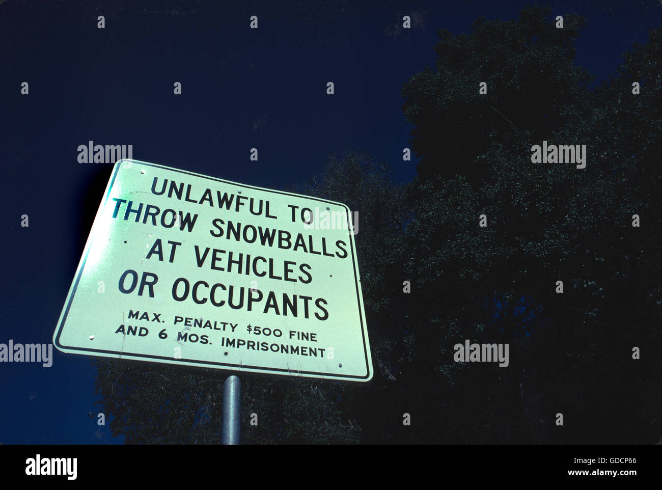 Serious, but humorous too, sign near the Palomar Mountain in San Diego County, California USA - Unlawful to Throw Snowballs at Vehicles or Occupants Stock Photo