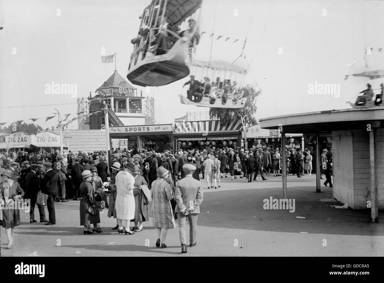 Fun Fair c1930. Note the fashions and 3d per game on The Wheel Of Fortune. Photograph by Tony Henshaw Stock Photo