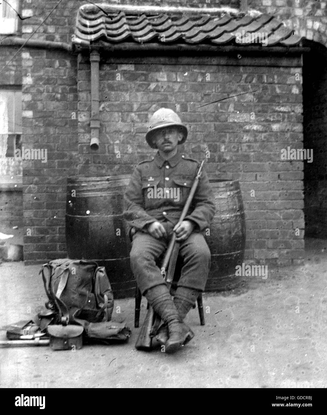 A British soldier poses in back yard with kit, c1914. Photograph by Tony Henshaw Stock Photo