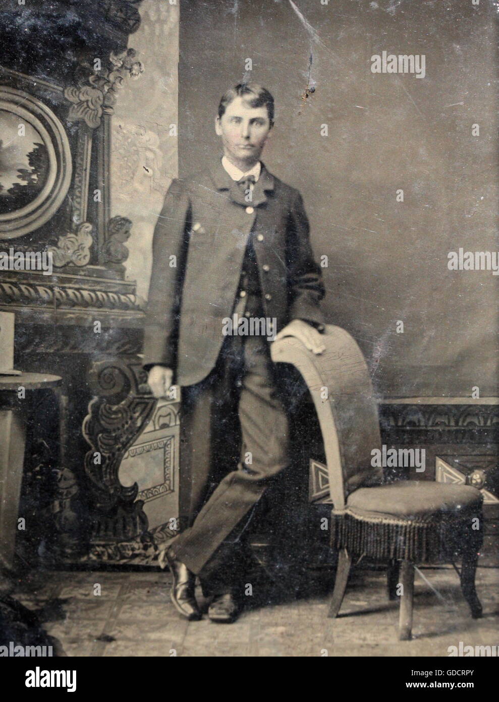 Tin-Type photograph of a young man posing by a chair c1890. Photograph by Tony Henshaw Stock Photo