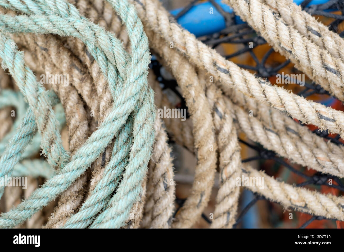 A tangle of old mooring ropes on a boat. Stock Photo