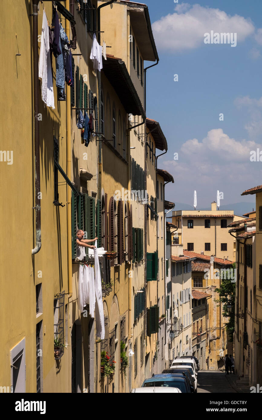 Hanging out the washing from a second floor window on Costa dell Magnoll, Florence, Tuscany, Italy Stock Photo