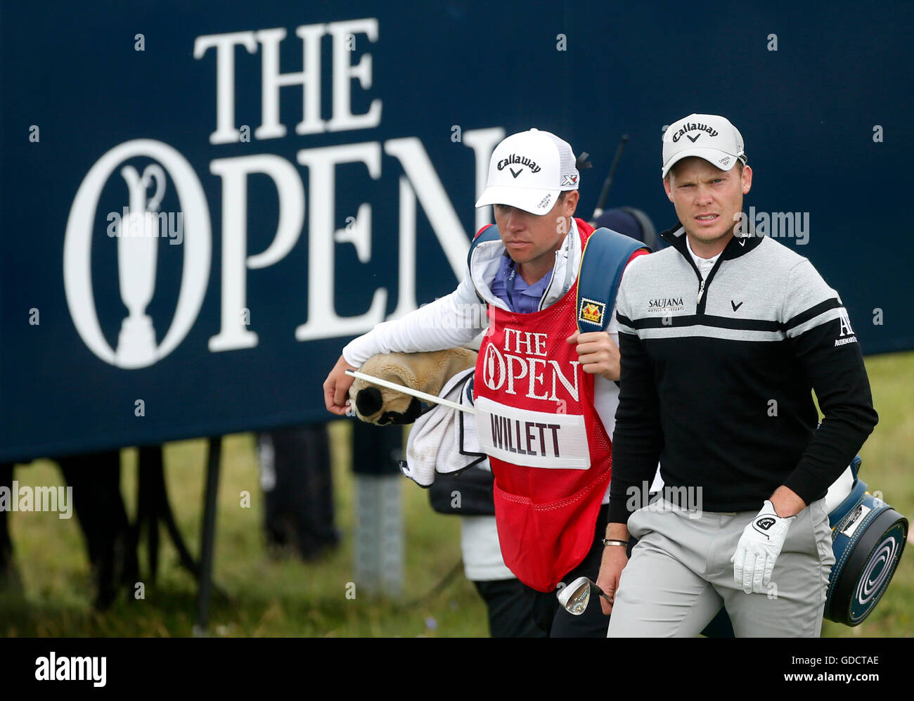 Danny Open England's Danny Willett walks past a 'The Open' sign during day two of ...