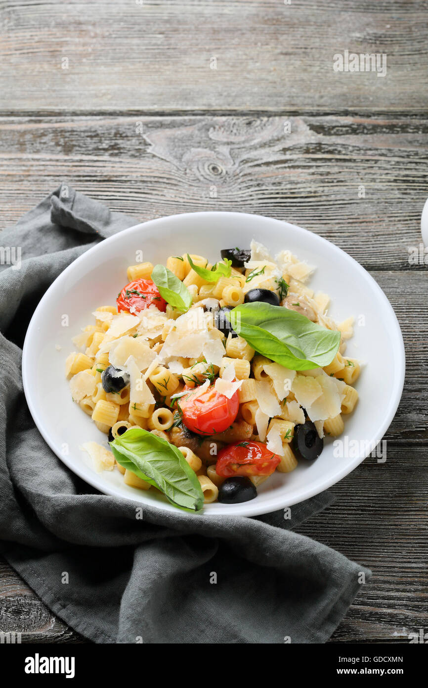 italian pasta with tomatoes and olives, food close-up Stock Photo