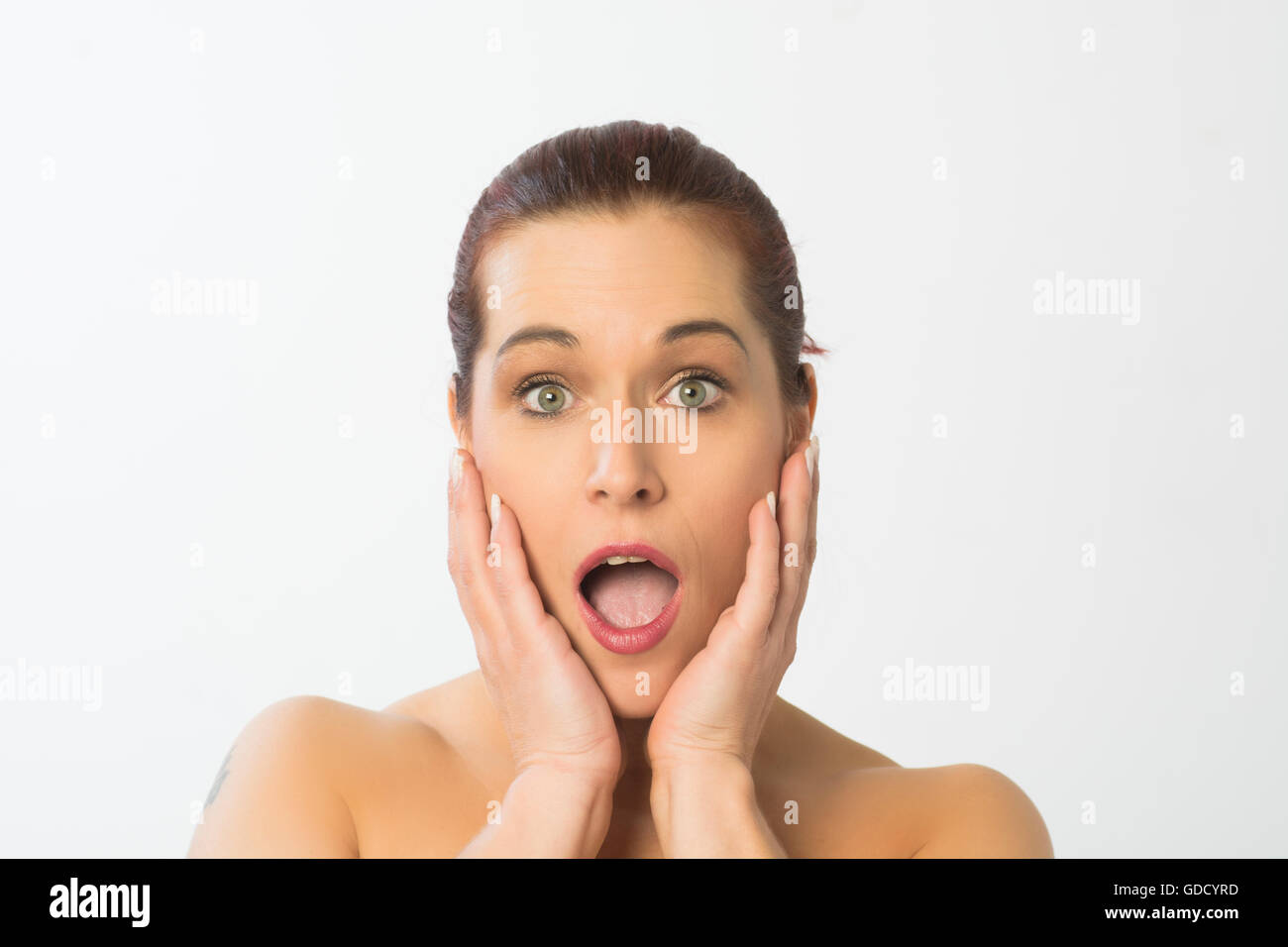 Shocked woman hands on face Stock Photo