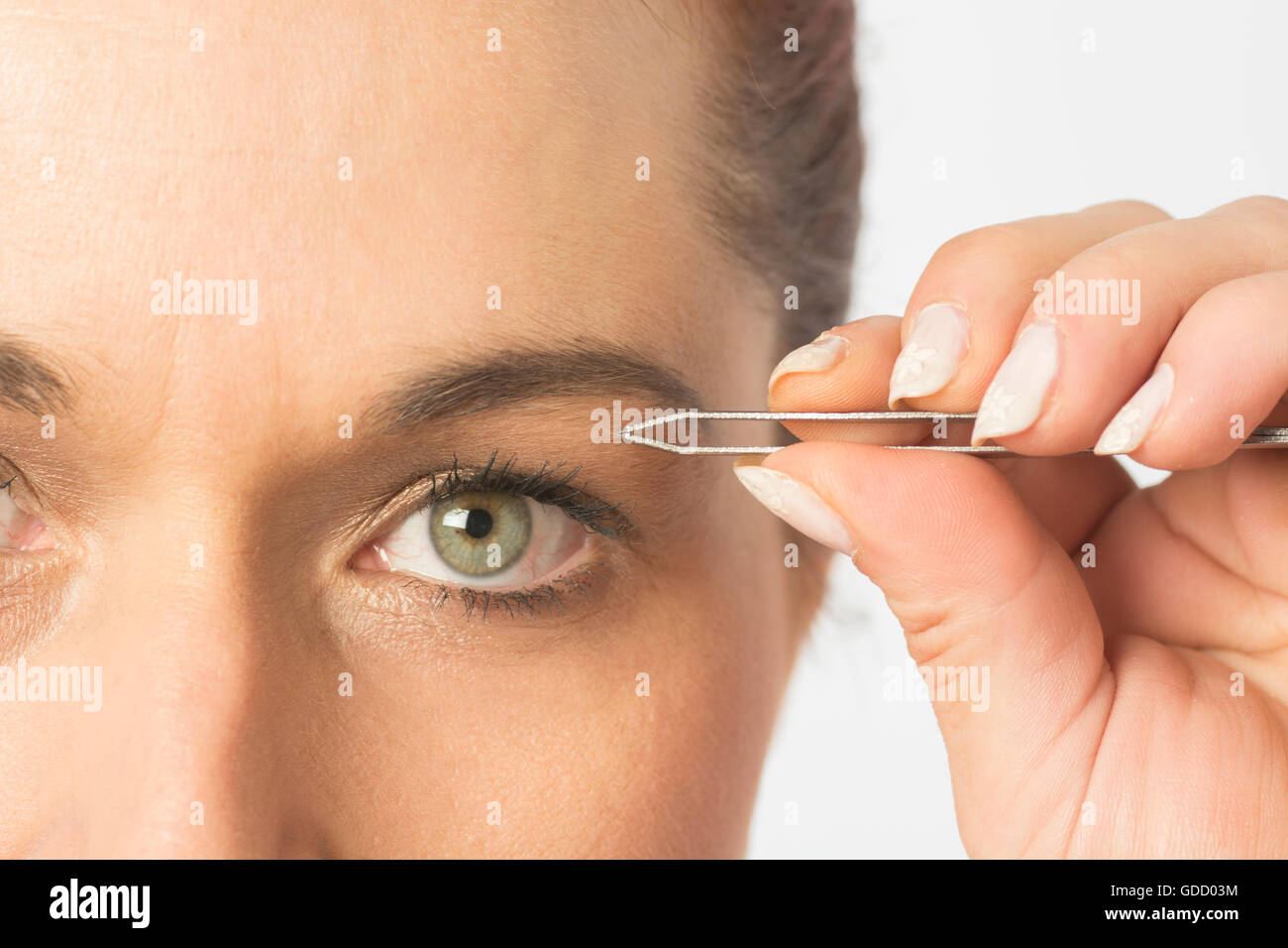 Close up of a woman plucking eyebrows with tweezers Stock Photo Alamy