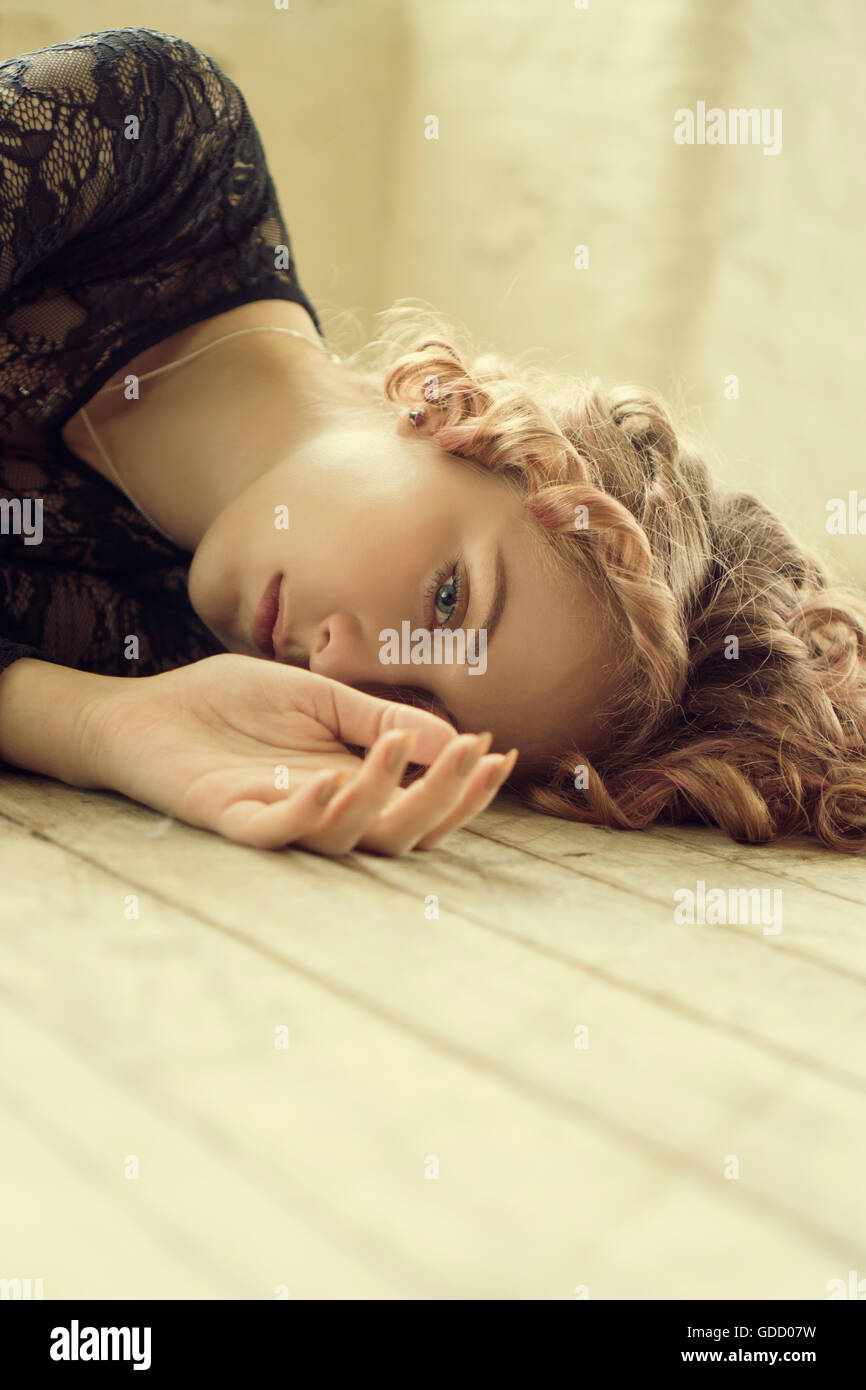 Portrait of a woman laying on the floor Stock Photo