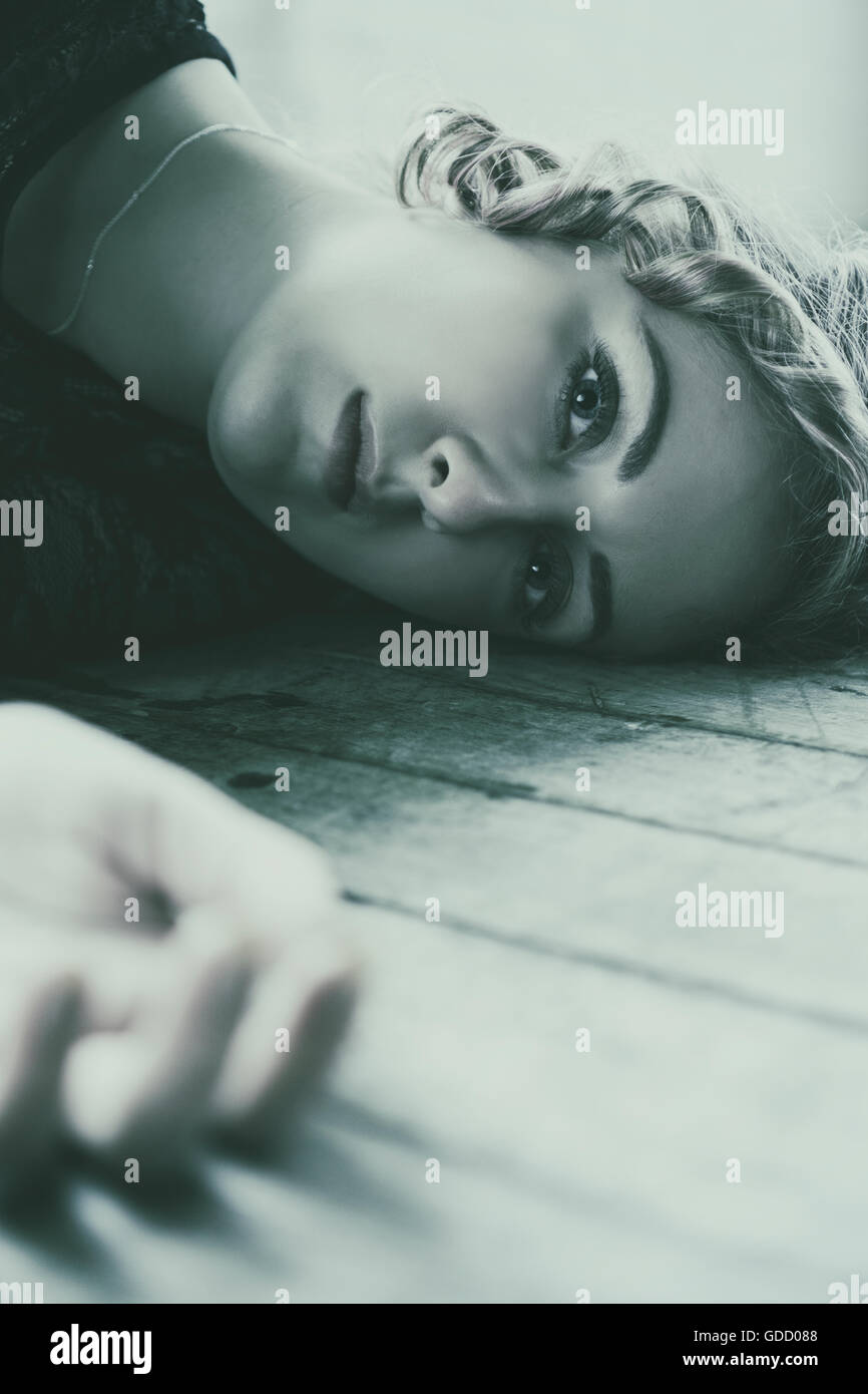 Portrait of a woman laying on the floor Stock Photo