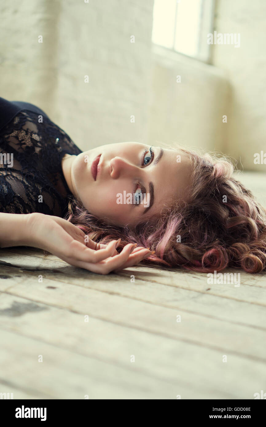 Portrait of a woman laying on the floor Stock Photo