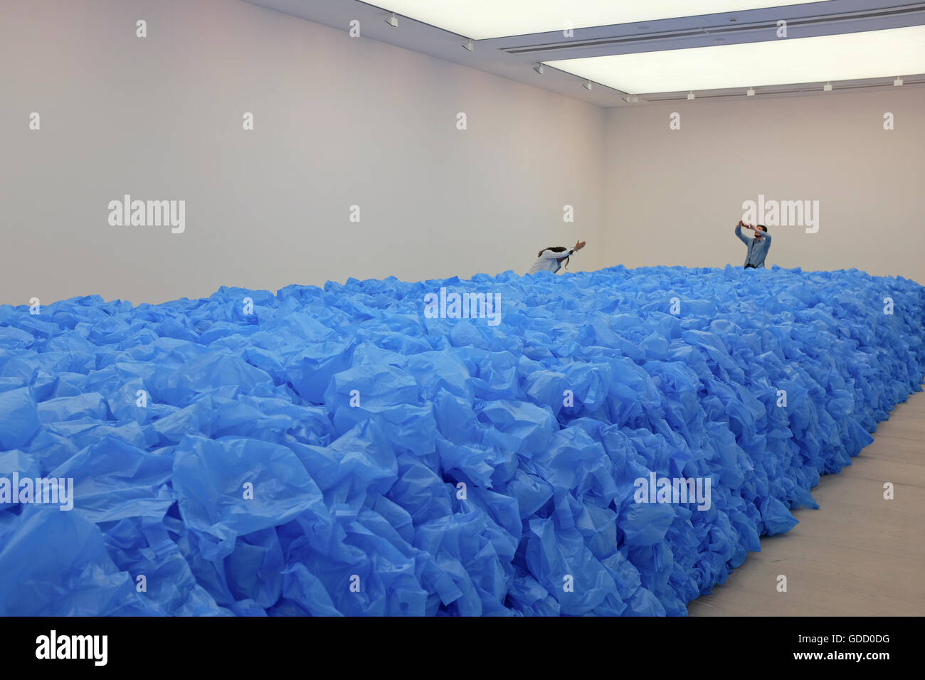 visitors posing with art installation (everything must go) at the saatchi gallery london Stock Photo