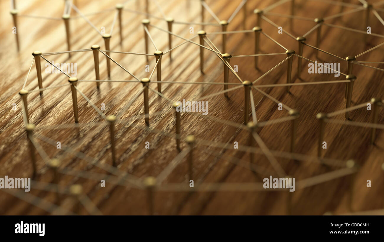 Network, networking, connect, wire. Linking entities. Network of gold wires on rustic wood. Nails connected with tether. Team work, team loyalty, Stock Photo