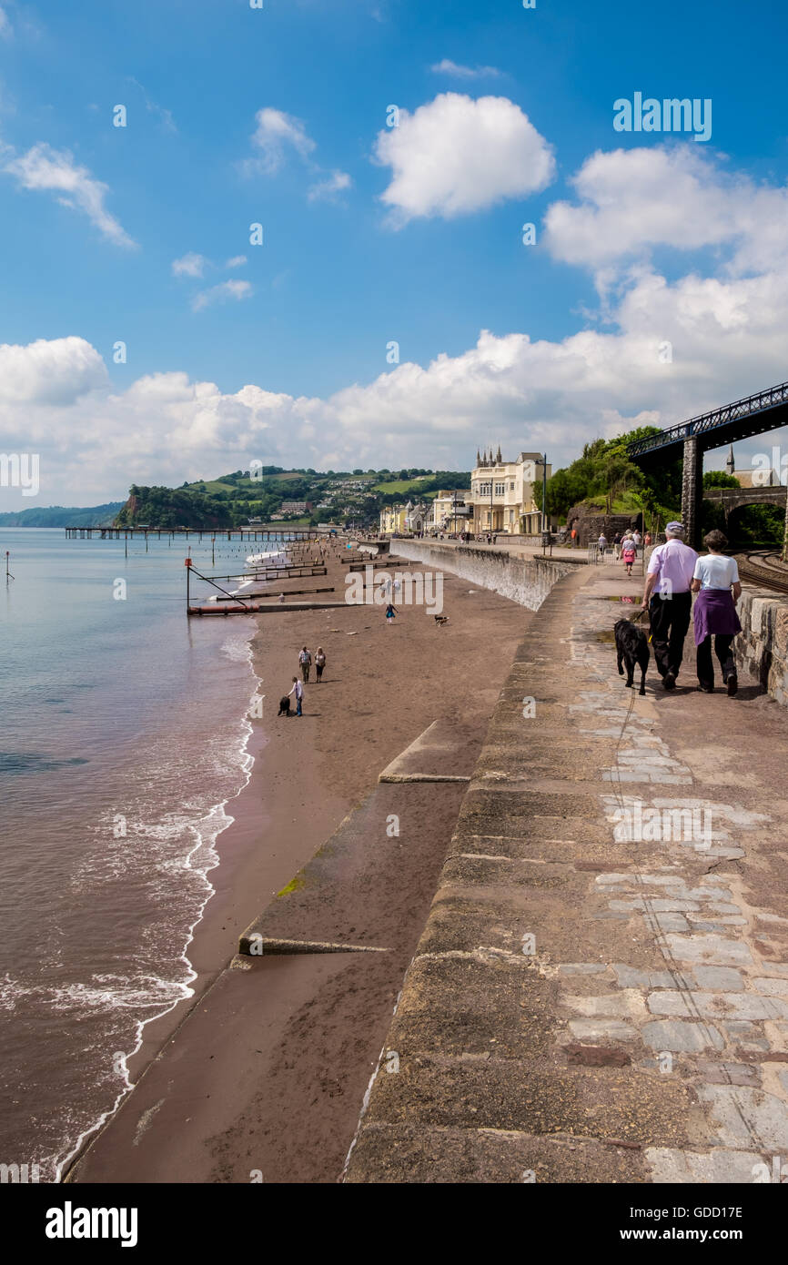 People walking along the sea wall at Teignmouth near Dawlish, Devon